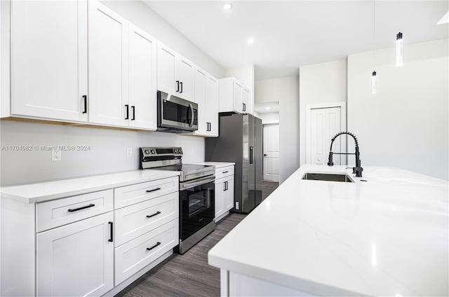 kitchen with white cabinets, stainless steel appliances, and dark wood-type flooring