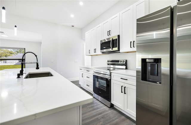 kitchen featuring white cabinets, dark hardwood / wood-style floors, sink, and appliances with stainless steel finishes