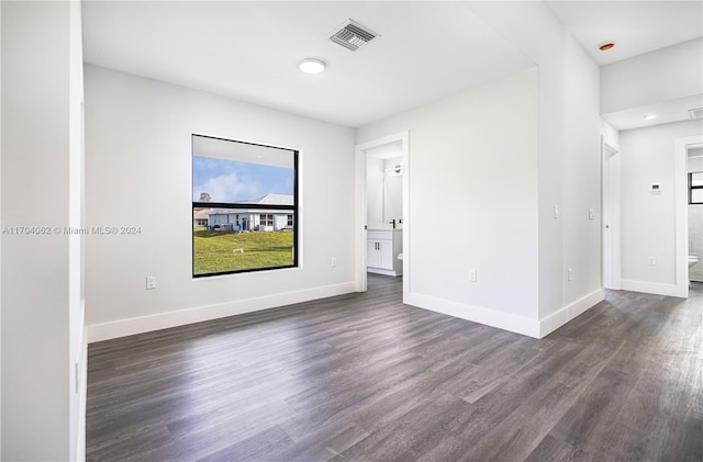 spare room with dark hardwood / wood-style floors