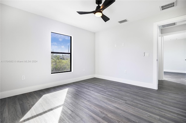 unfurnished room with ceiling fan and dark wood-type flooring