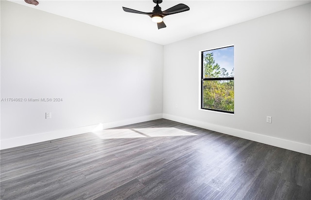 empty room with ceiling fan and dark wood-type flooring