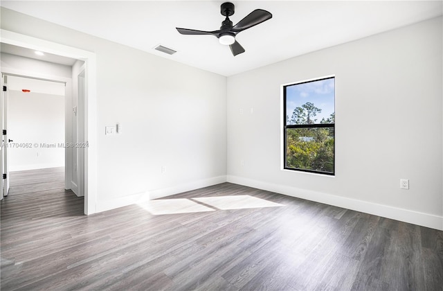 empty room featuring ceiling fan and dark hardwood / wood-style floors