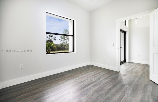 empty room with dark hardwood / wood-style floors