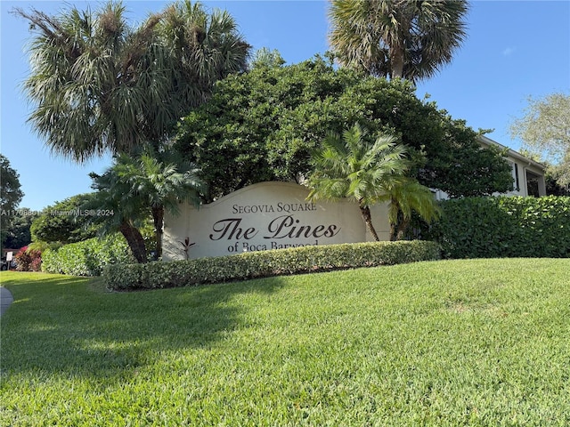 community sign featuring a lawn