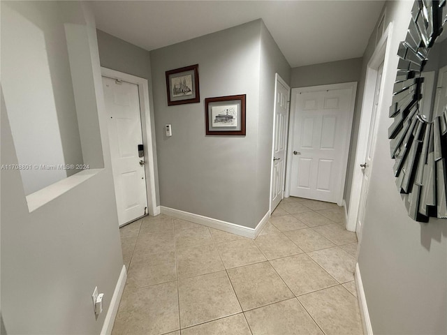 hall featuring light tile patterned floors