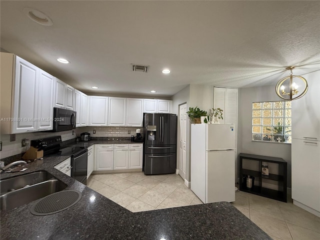 kitchen with black appliances, white cabinets, sink, a notable chandelier, and light tile patterned flooring