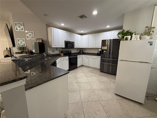 kitchen with kitchen peninsula, black appliances, light tile patterned floors, dark stone countertops, and white cabinetry