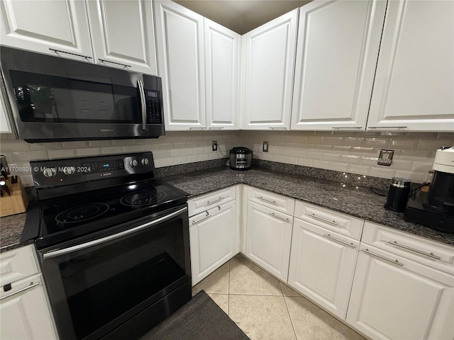 kitchen featuring white cabinets, black range with electric cooktop, backsplash, and light tile patterned flooring