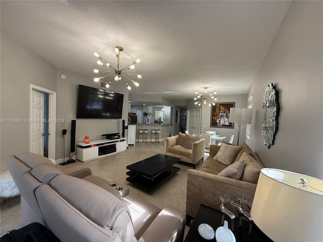 tiled living room featuring a textured ceiling and an inviting chandelier