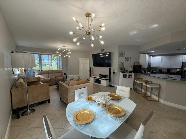 dining room featuring a textured ceiling, a notable chandelier, and light tile patterned flooring