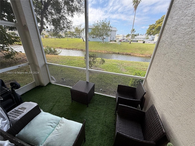 sunroom / solarium with a water view