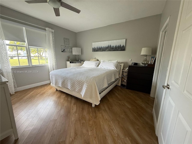 bedroom with wood-type flooring and ceiling fan