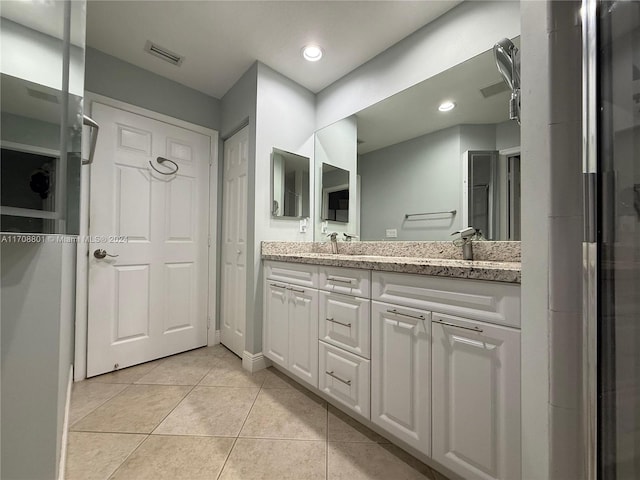 bathroom with tile patterned flooring and vanity