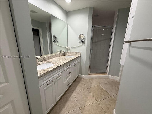 bathroom featuring vanity, tile patterned floors, and walk in shower