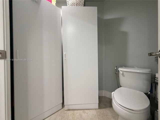 bathroom featuring tile patterned flooring and toilet