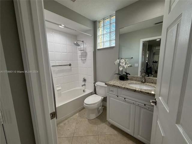 full bathroom featuring tile patterned floors, a textured ceiling, vanity, toilet, and tiled shower / bath