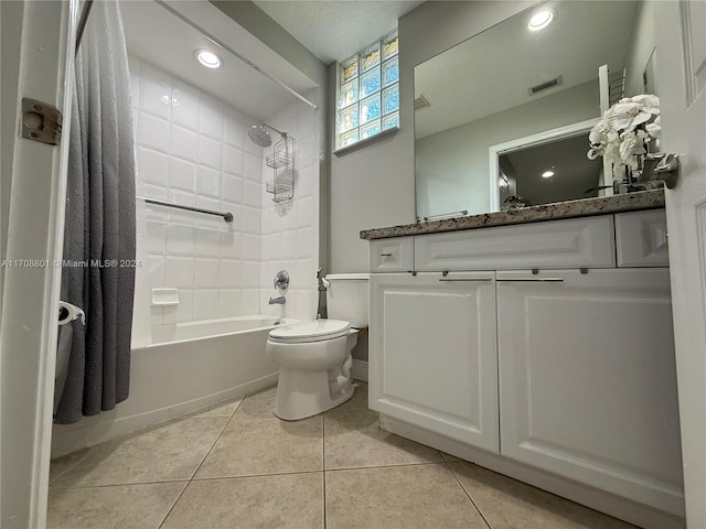 full bathroom with shower / bath combo with shower curtain, tile patterned flooring, vanity, and toilet