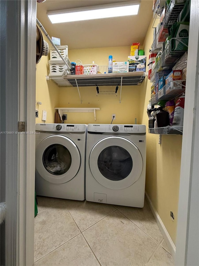 laundry room featuring tile patterned floors and washer and dryer