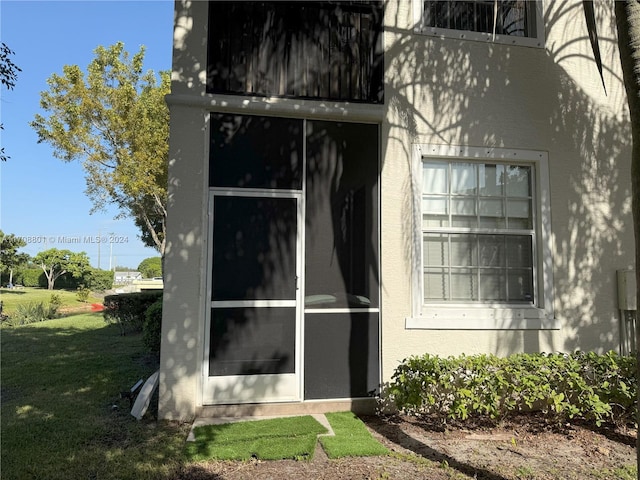 view of side of home with a yard