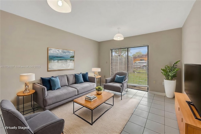 living room featuring baseboards and light tile patterned flooring