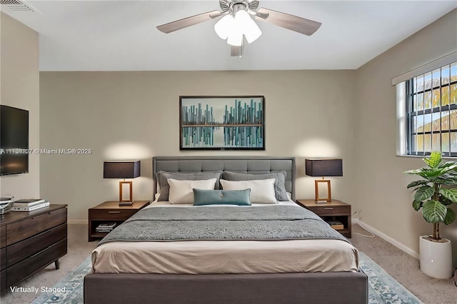 bedroom with baseboards, a ceiling fan, visible vents, and light colored carpet