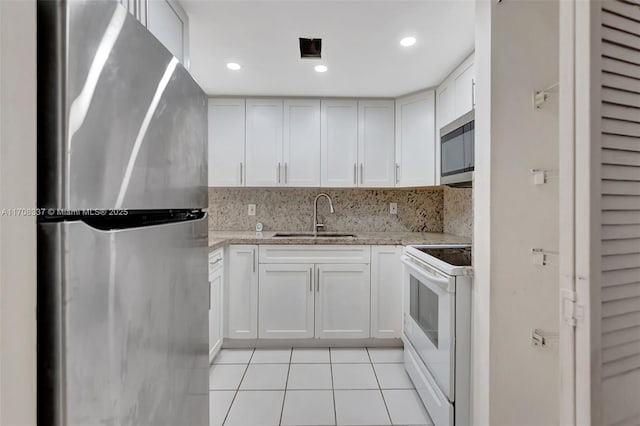 kitchen featuring white cabinets, stainless steel appliances, and a sink