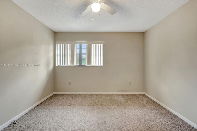 empty room with carpet, baseboards, ceiling fan, and a textured ceiling