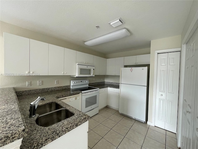 kitchen featuring a textured ceiling, white appliances, white cabinetry, and sink