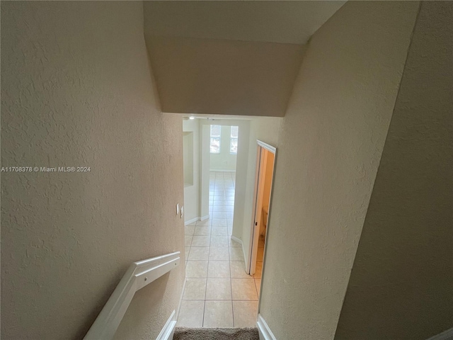 hall featuring light tile patterned floors