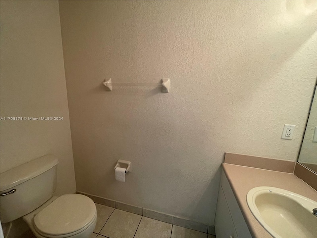 bathroom featuring tile patterned flooring, vanity, and toilet