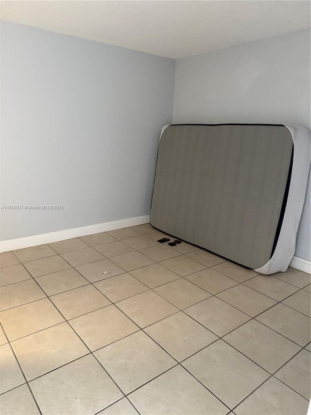 unfurnished bedroom with light tile patterned floors