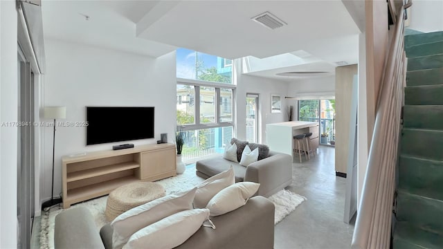 living area with finished concrete floors and visible vents