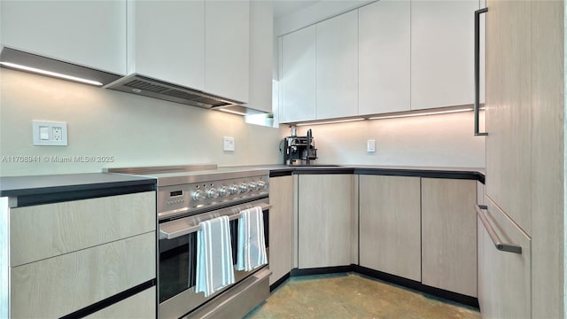 kitchen featuring a sink, modern cabinets, stainless steel range with electric stovetop, concrete floors, and under cabinet range hood