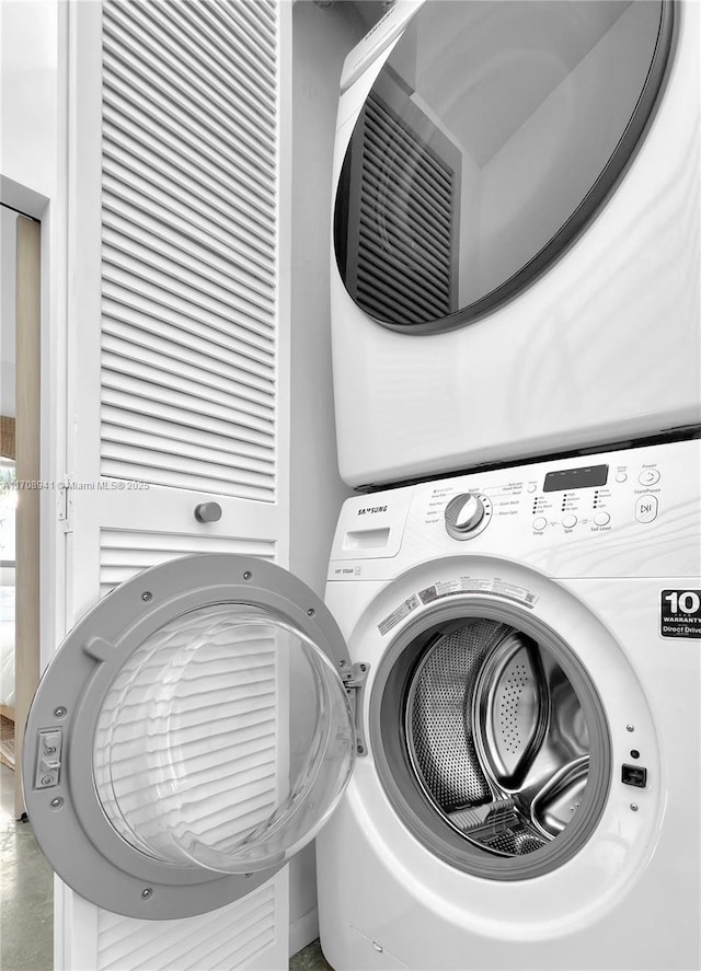 washroom featuring laundry area and stacked washing maching and dryer