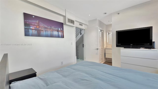 bedroom featuring recessed lighting, a closet, and visible vents