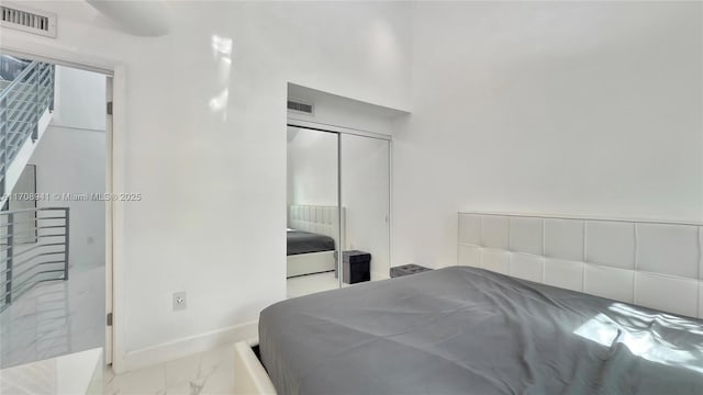 734 Michigan Ave Unit 7And 6, Miami Beach, FL 33139 - bedroom featuring marble look tile flooring, baseboards, and a closet