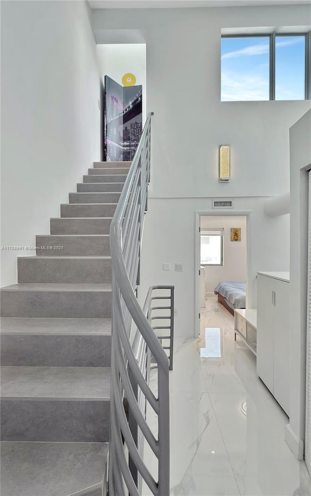 734 Michigan Ave Unit 7And 6, Miami Beach, FL 33139 - stairs featuring marble finish flooring and a high ceiling