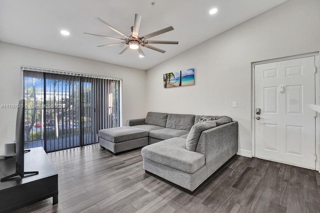 living room featuring hardwood / wood-style flooring, vaulted ceiling, and ceiling fan