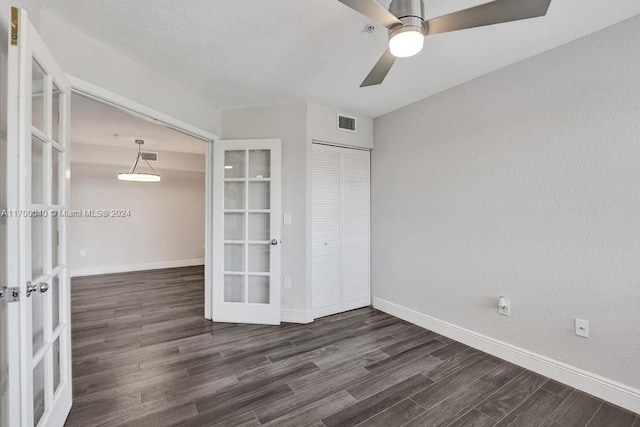 spare room featuring ceiling fan, dark hardwood / wood-style floors, and french doors