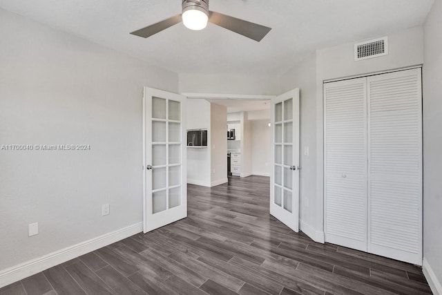 interior space with ceiling fan, french doors, and dark wood-type flooring