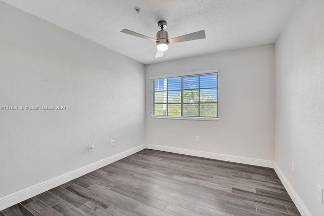 unfurnished room with hardwood / wood-style flooring, ceiling fan, and a textured ceiling