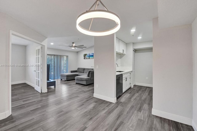 living room with ceiling fan, hardwood / wood-style floors, french doors, and sink