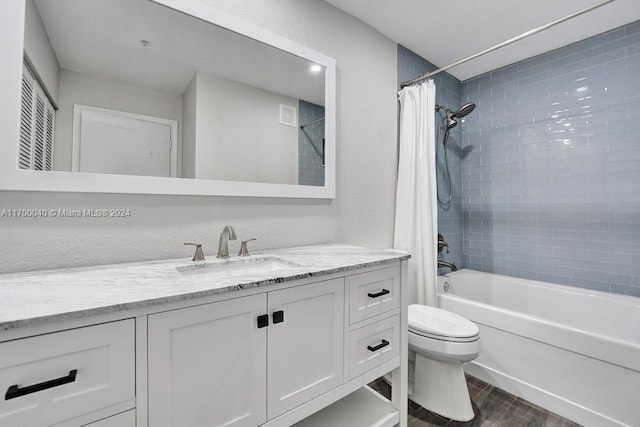 full bathroom with vanity, shower / bath combination with curtain, and toilet