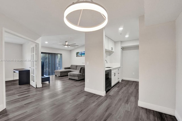 interior space with ceiling fan, sink, and wood-type flooring