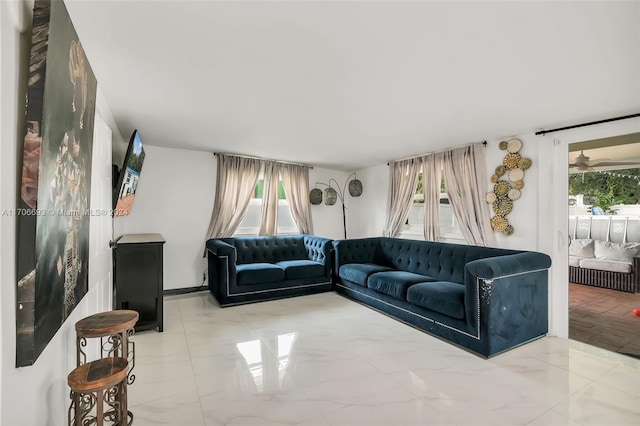 living room featuring plenty of natural light and ceiling fan