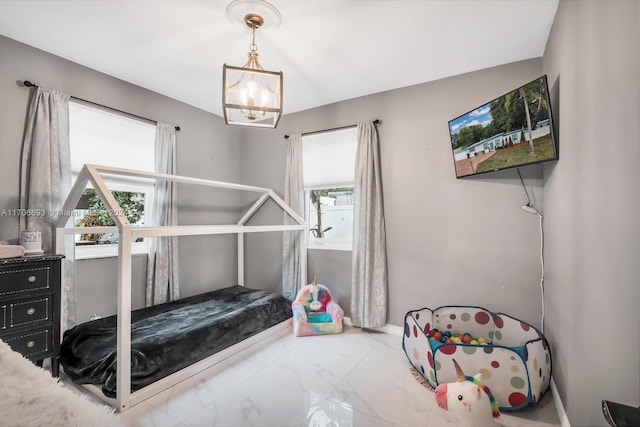 bedroom with a notable chandelier