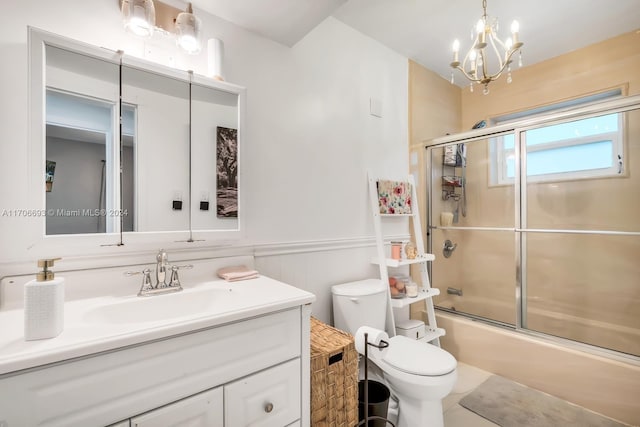 full bathroom featuring vanity, toilet, shower / bath combination with glass door, and an inviting chandelier