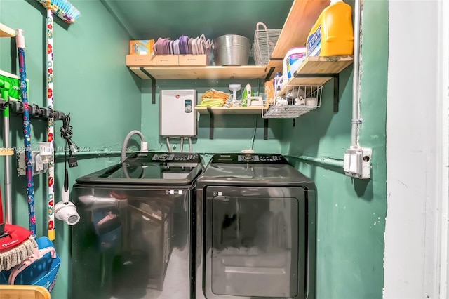 clothes washing area with washing machine and dryer