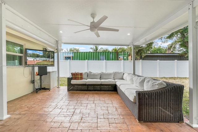 sunroom / solarium featuring a wealth of natural light and ceiling fan