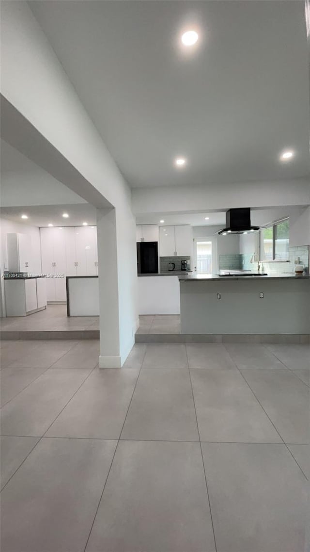 unfurnished living room with baseboards, light tile patterned flooring, and recessed lighting